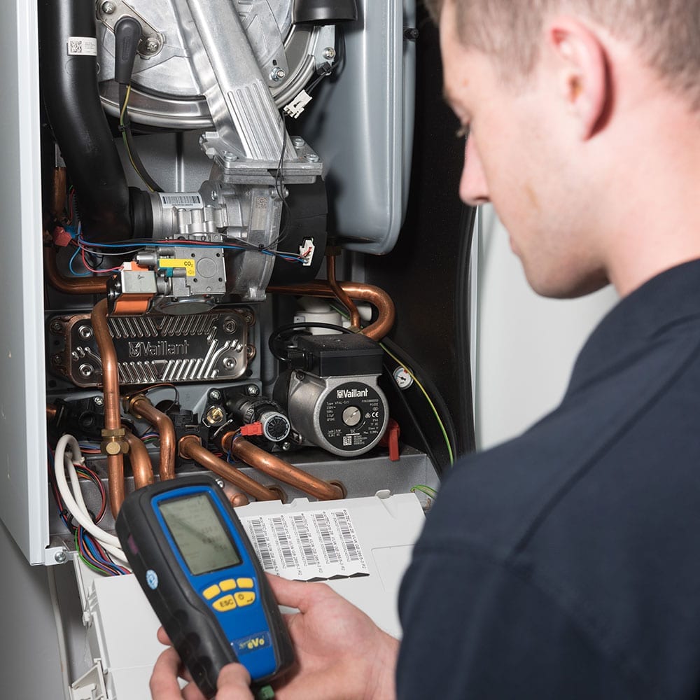 A Taskforce engineer taking an energy reading at a boiler.