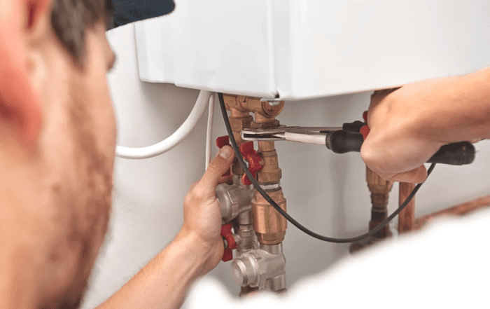 person servicing boiler